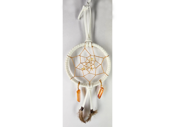 A white dream catcher with quartz crystals and feathers.