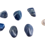 Large tumbled blue quartz stone in soft shades of sky blue with subtle marbling, shown next to a quarter for size comparison, the stones are larger than the quarter.