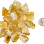 A pile of small tumbled citrine, with a light hone color, with some milky white, and translucency to the stones, with a quarter for comparison. All are slightly smaller than the quarter.