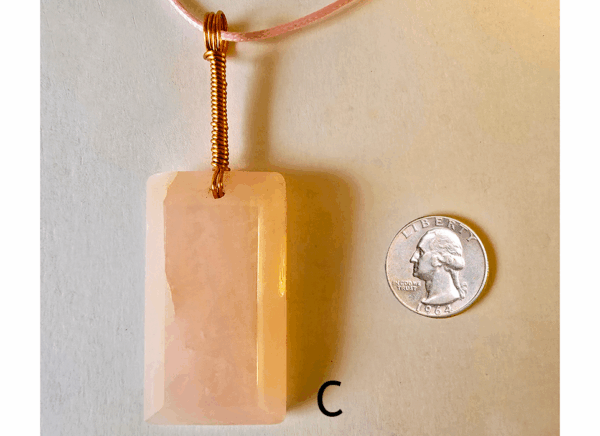A pink rose quartz faceted pendant with a copper wire wrapped bail, and a quarter for size comparison. Labeled C.