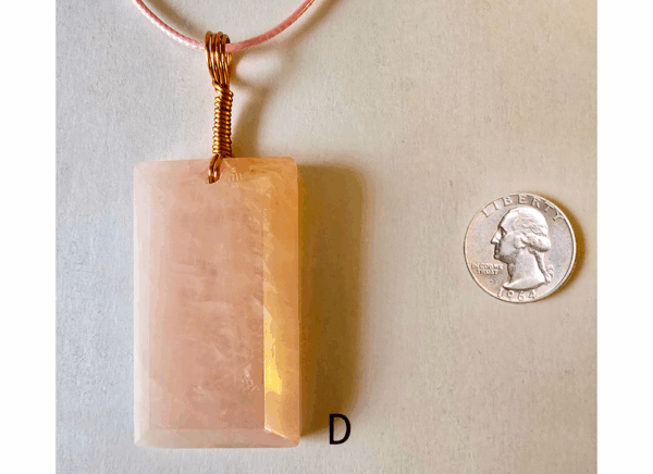 A pink rose quartz faceted pendant with a copper wire wrapped bail, and a quarter for size comparison. Labeled D.