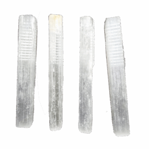 A group of 4 selenite sticks with a soft white glow.