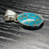 Sterling silver turquoise pendant with copper matrix.